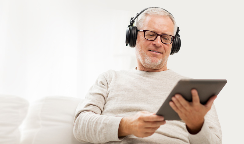 man listening to usa radio on tablet computer